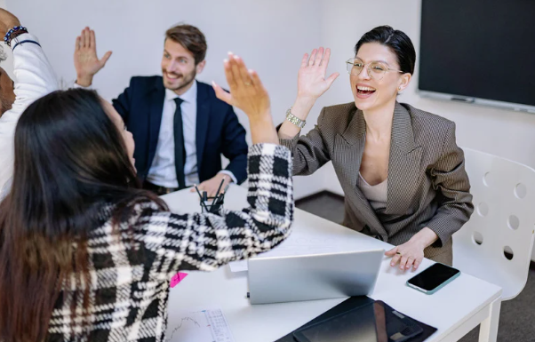 Business people high-fiving after achieving business goals
