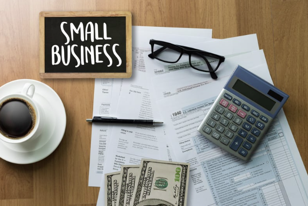 Small business finance, Picture of calculator, tax forms, and money