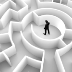 Work-life balance challenges shown by business man trying to get out of a maze.